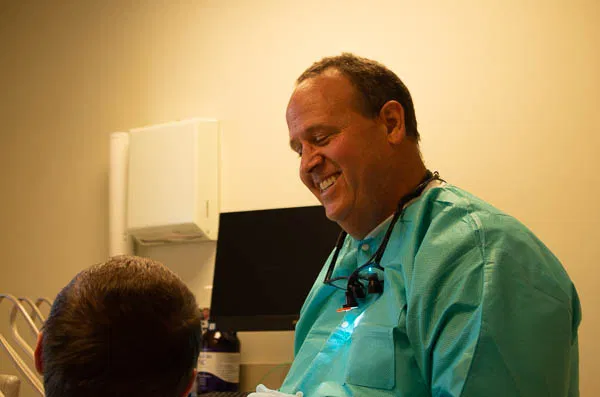 photograph of Dr. Charles Nelson, III with patient at Nelson Dental Practice